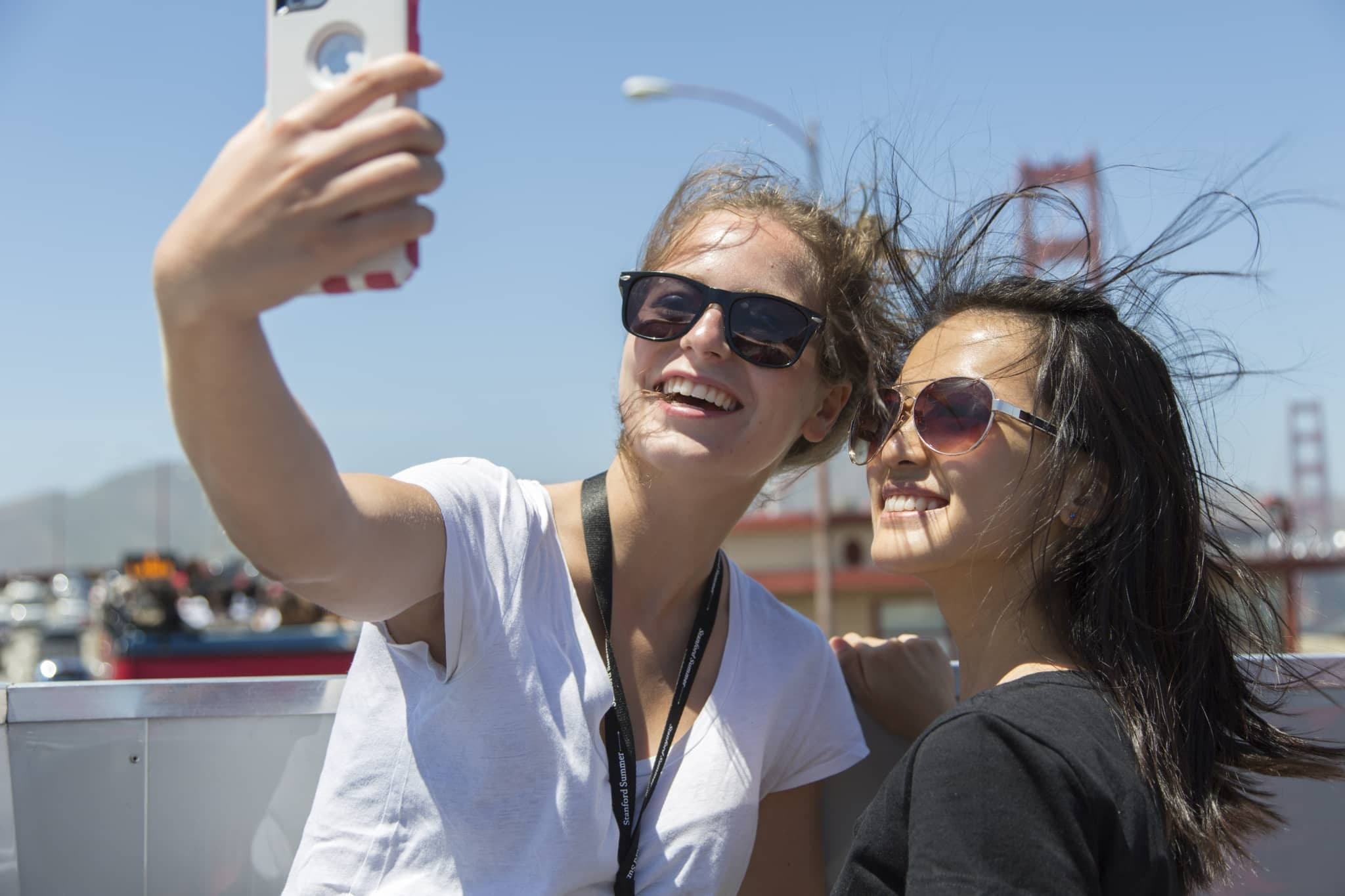 Students take a selfie in front of the Golden Gate Bridge.