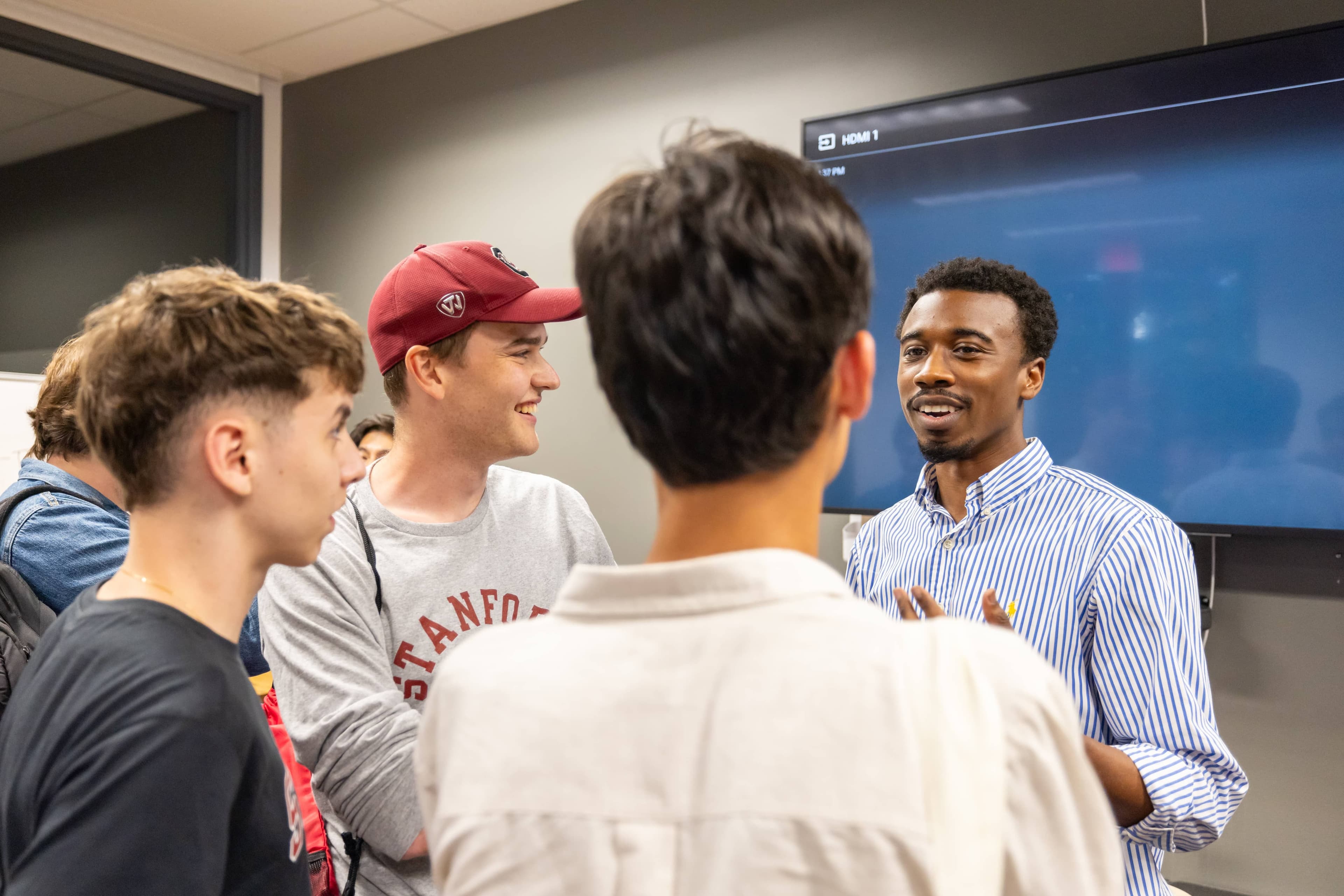 Students gather around a panelist from Stanford Biodesign.